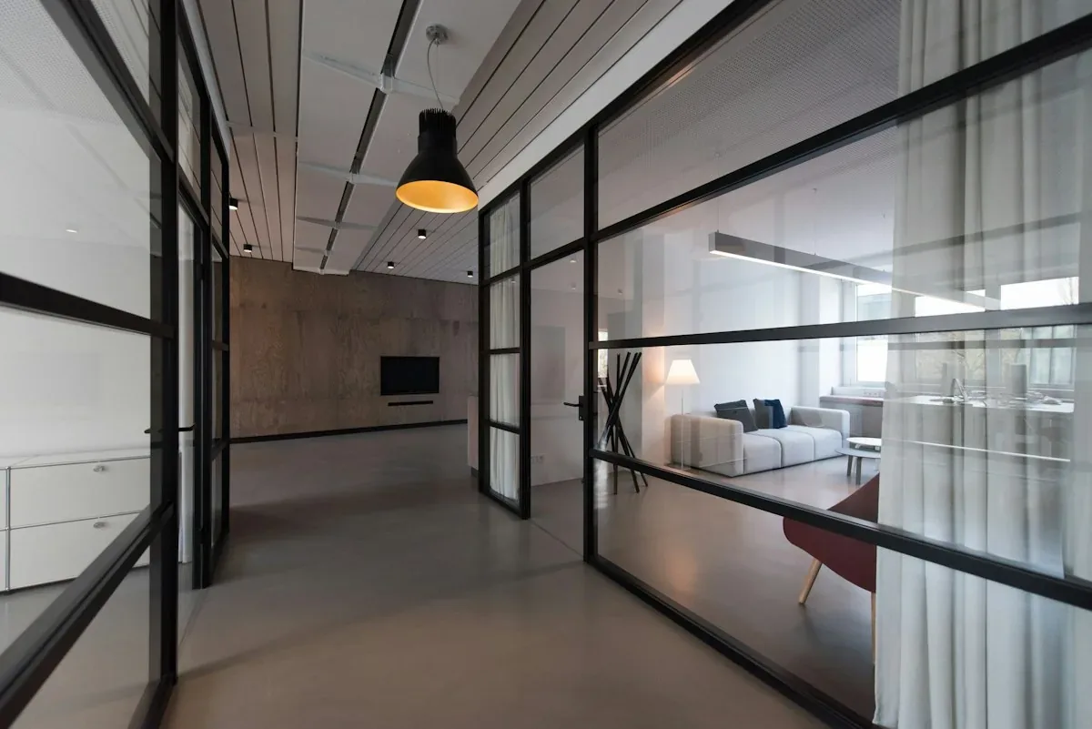 Contemporary interior with a glass divider and white curtain